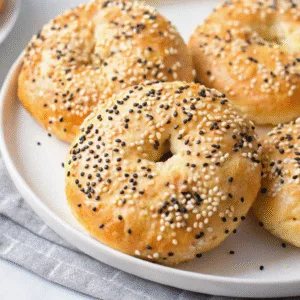 High Protein Bagels: Quick, Healthy, and Packed with Flavor High Protein Bagels Freshly baked high protein bagels on white plate with sesame topping