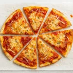 Cottage cheese pizza crust sliced on parchment