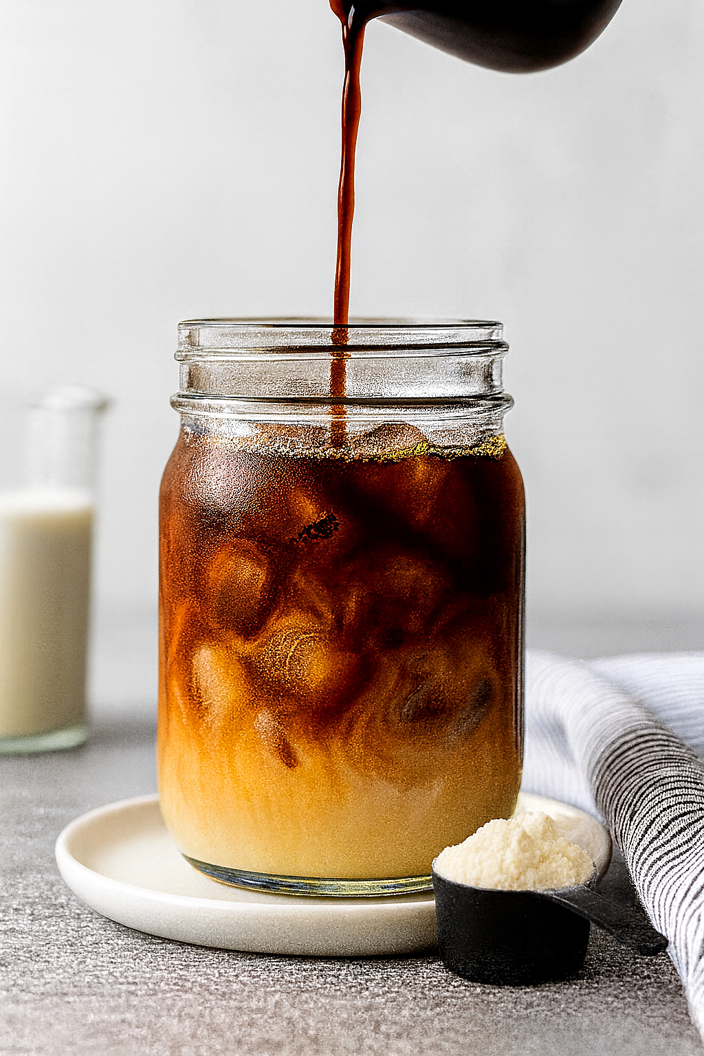 step3-add-coffee-protein-coffee-recipe Cold espresso poured into milk and ice for iced protein coffee